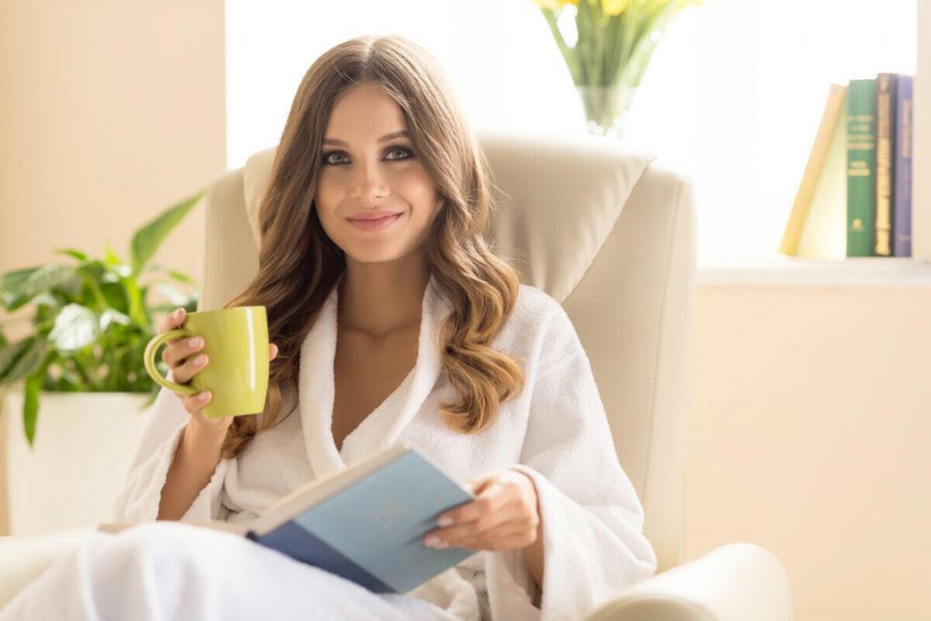 Woman having tea and reading about plastic surgery.